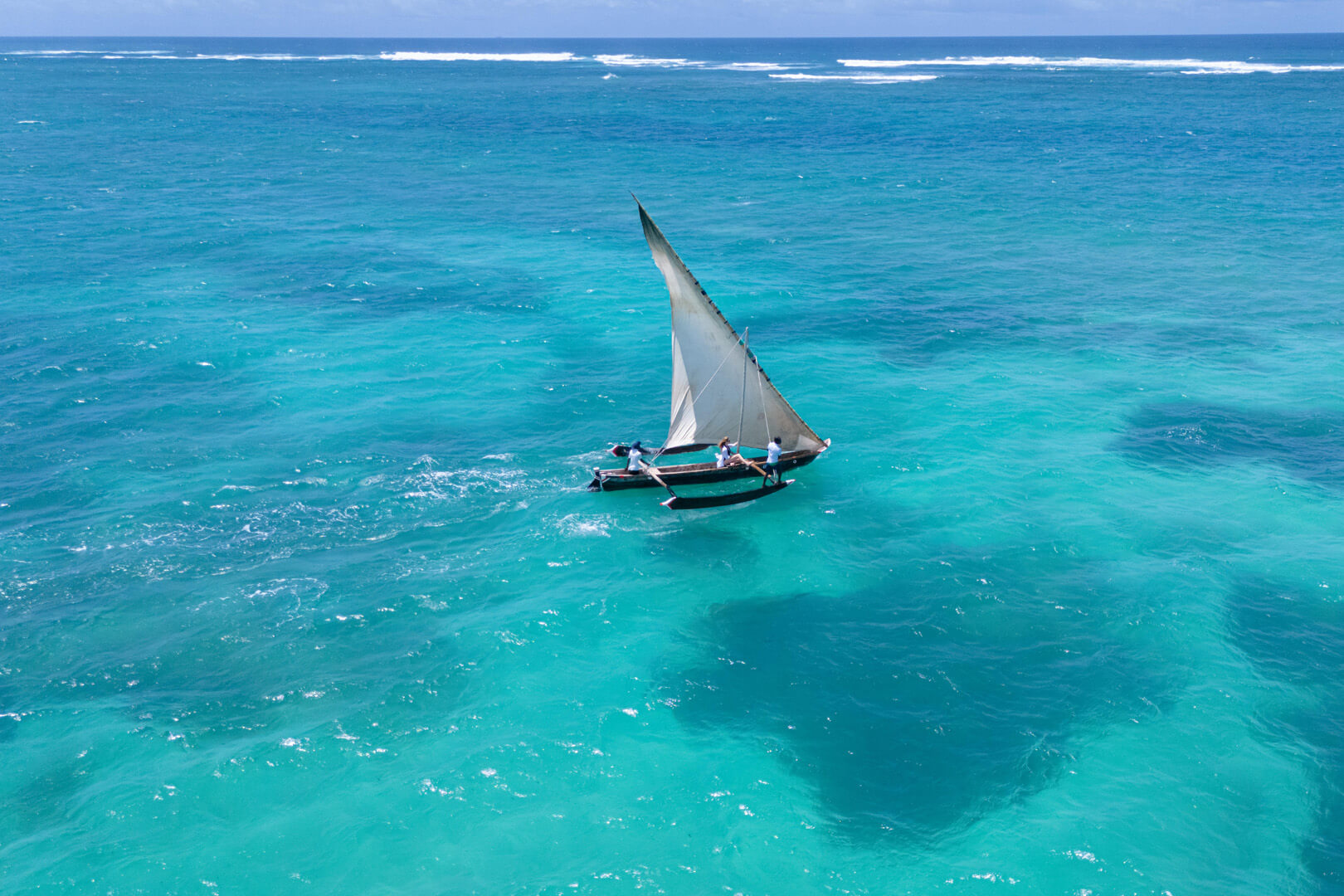 Drone photo capturing the vivid blue waters in front of Almanara Villas